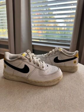 Nike Kids White Sneakers with Black Swoosh and Yellow Accents